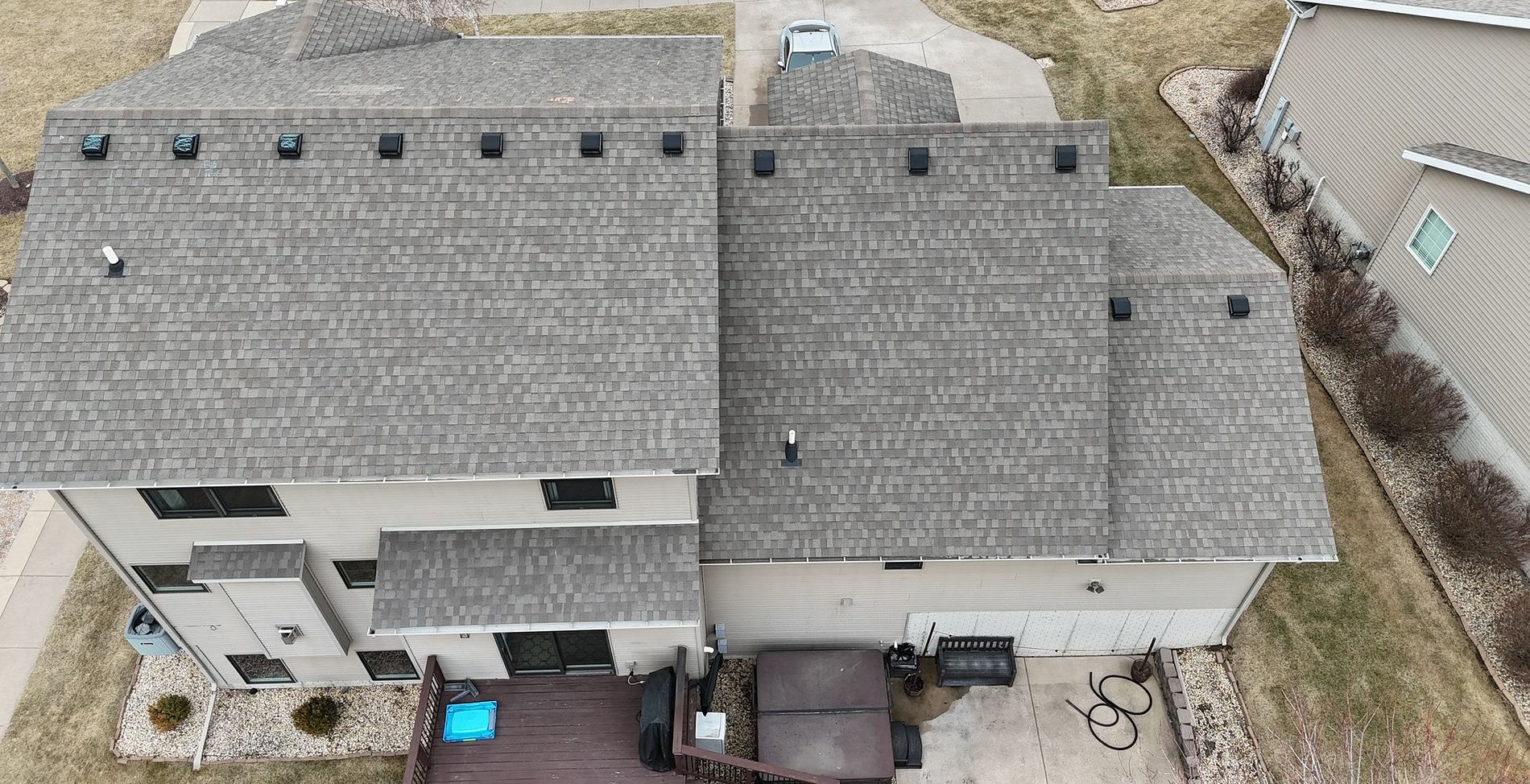 Worn gray shingles on the back of a Bettendorf, Iowa home before Mitten's roof replacement