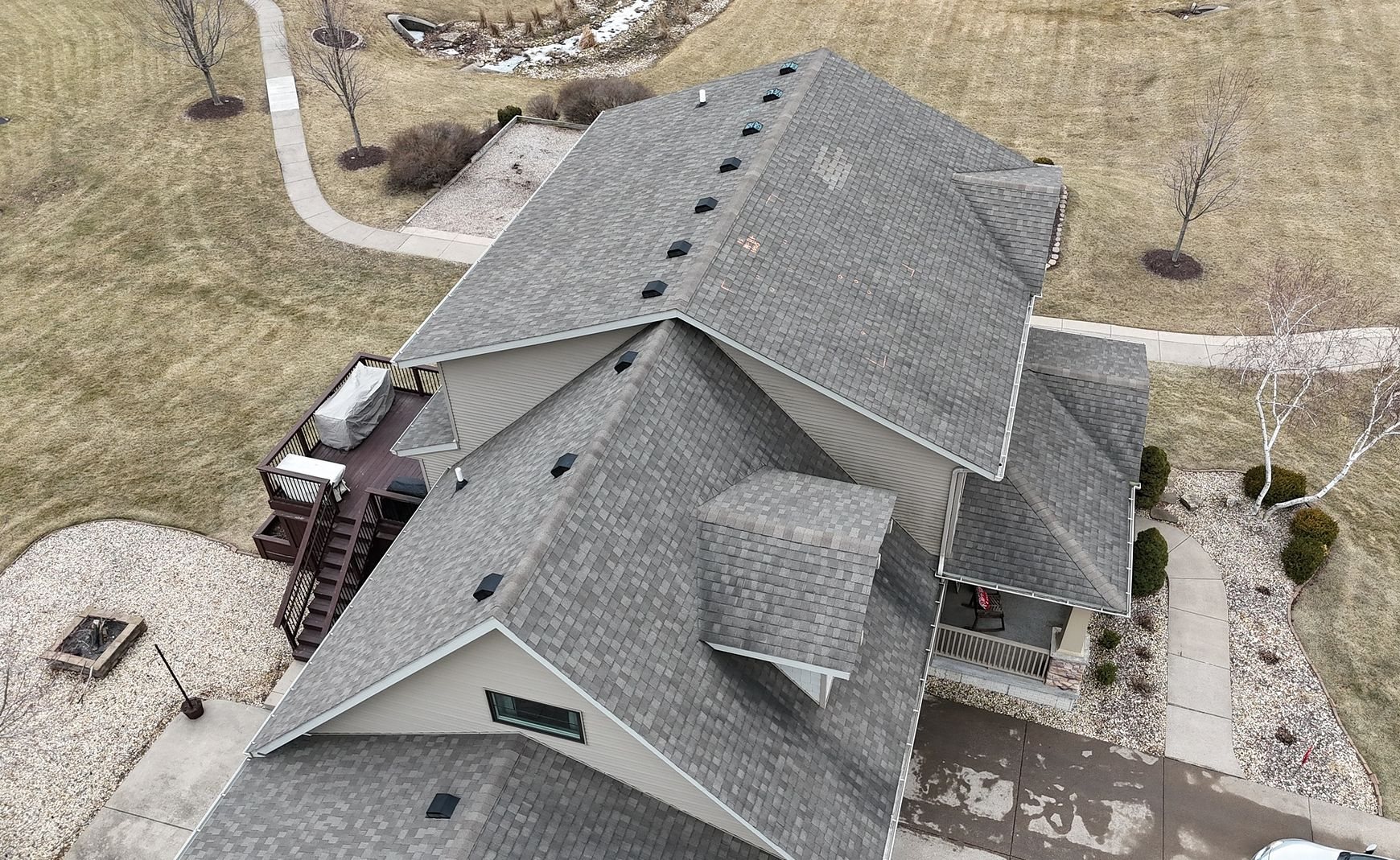 Weathered gray shingles with marked damage on a Bettendorf, Iowa home before Mitten's roof replacement