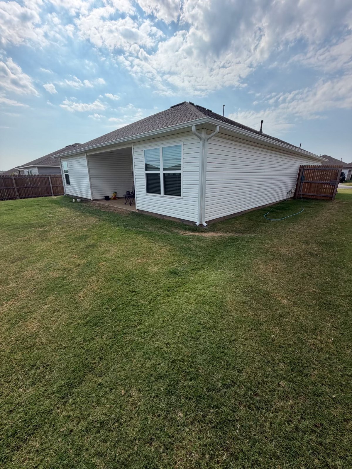 Finished home exterior with white siding and gutters in Claremore, Oklahoma