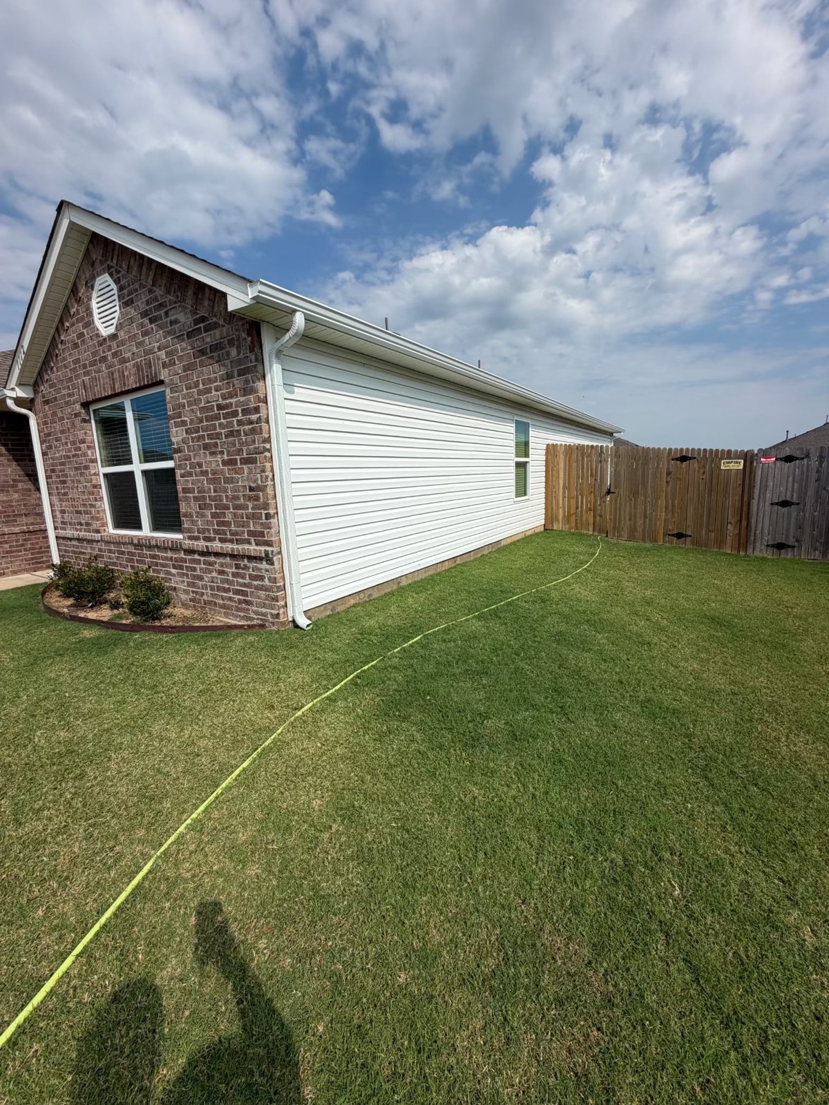 Finished home exterior with white siding and gutters in Claremore, Oklahoma