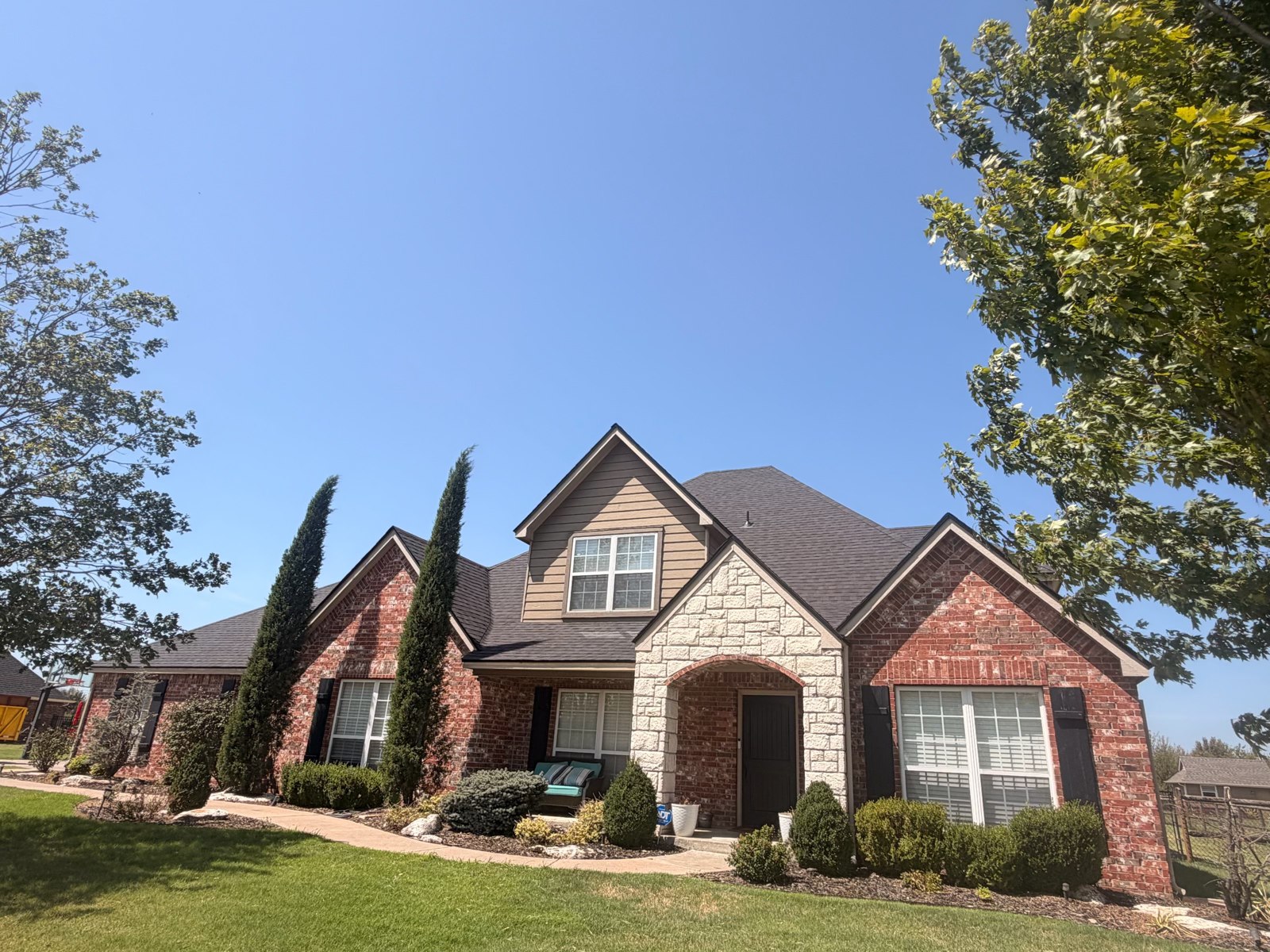 Finished shingle roof on a brick home in Collinsville, Oklahoma
