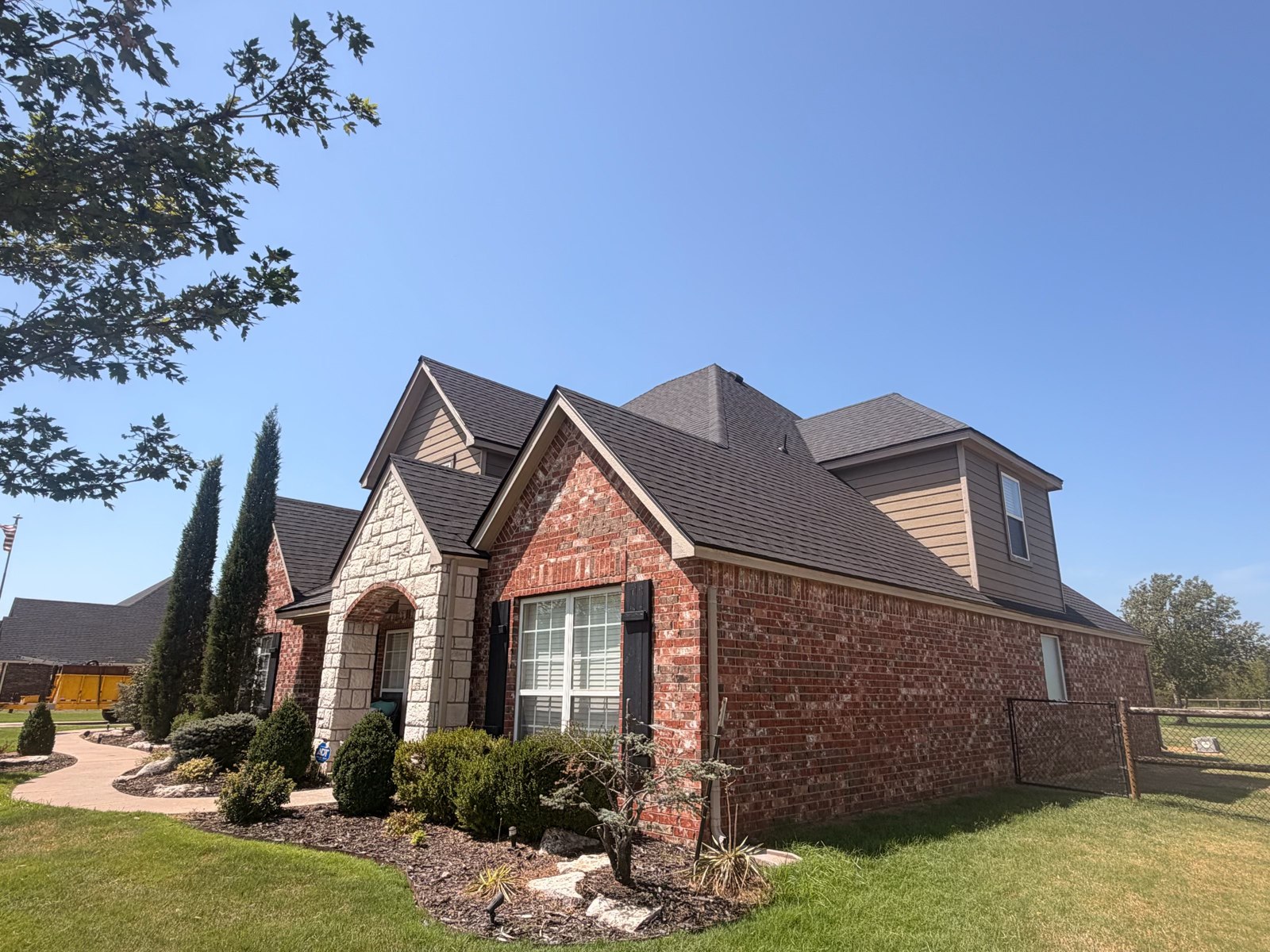Finished shingle roof on a brick home in Collinsville, Oklahoma