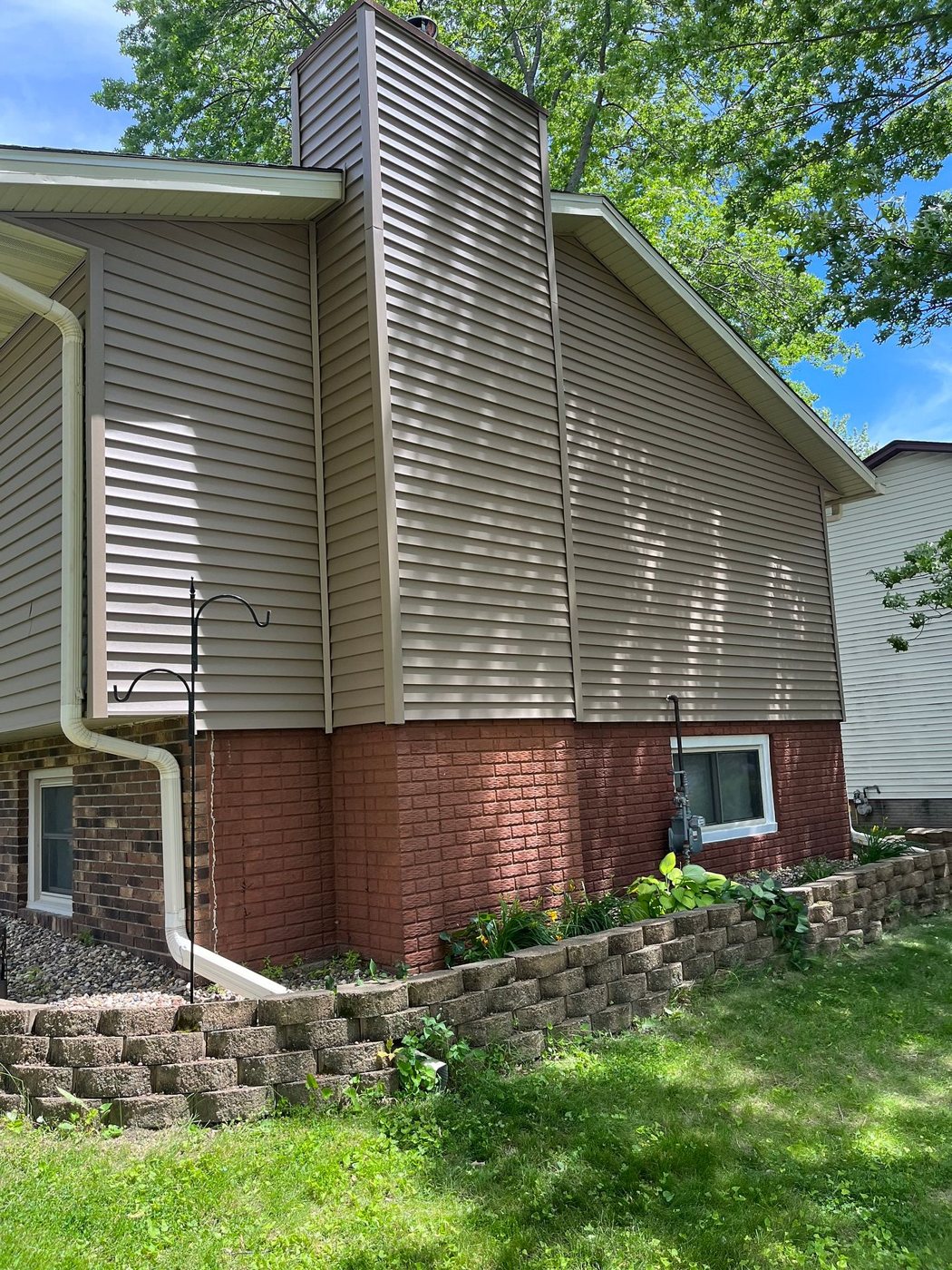 Royal Estate vinyl siding in Walnut on the gable and chimney chase of a home in Eldridge, Iowa