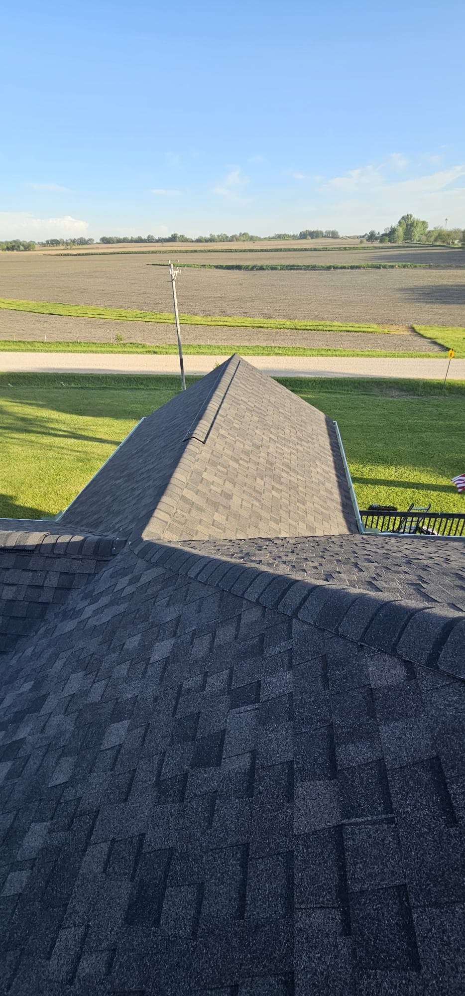 Completed shingle roof with ridge caps on a Long Grove, Iowa home